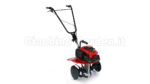 Mini-motozappa a scoppio Honda FG 205 rossa con frese rotative e dischi laterali di protezione, vista di tre quarti su sfondo bianco.